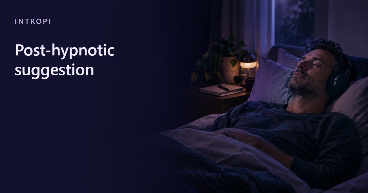 A man lies back on his bed in the evening wearing headphones, a closed notebook on the bedside table.